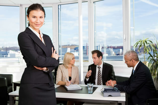 woman standing in front of her business team discussing tax compliance