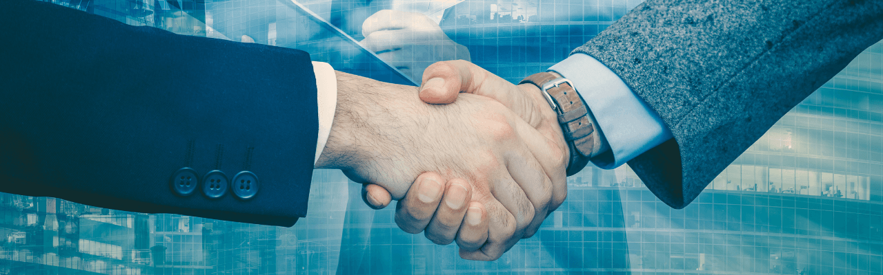 Business professionals shaking hands with overlay icons symbolising the special economic zone meaning in practice.